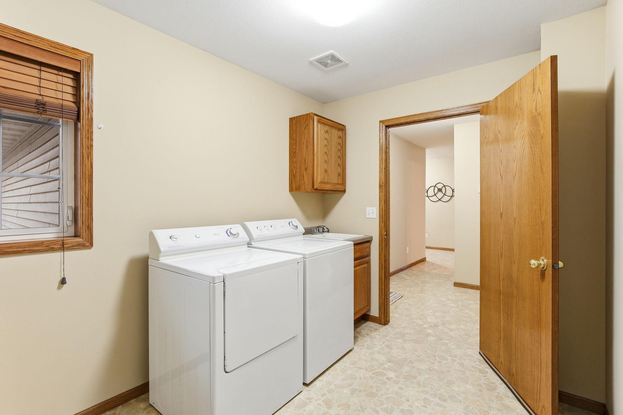 Extra-large laundry room with window for natural light and additional storage space.