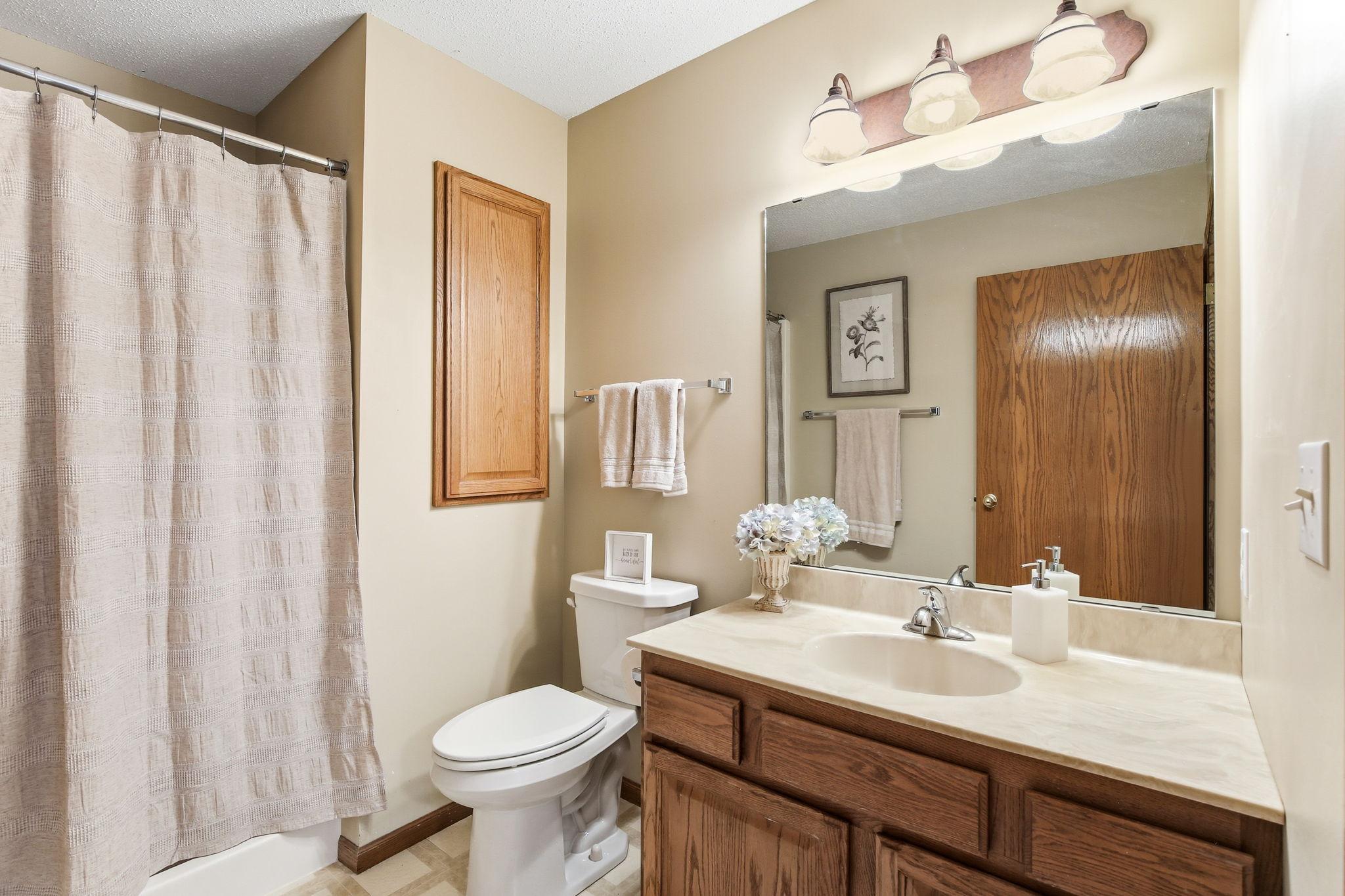 Full bathroom with tub/shower and solid, functional layout.
