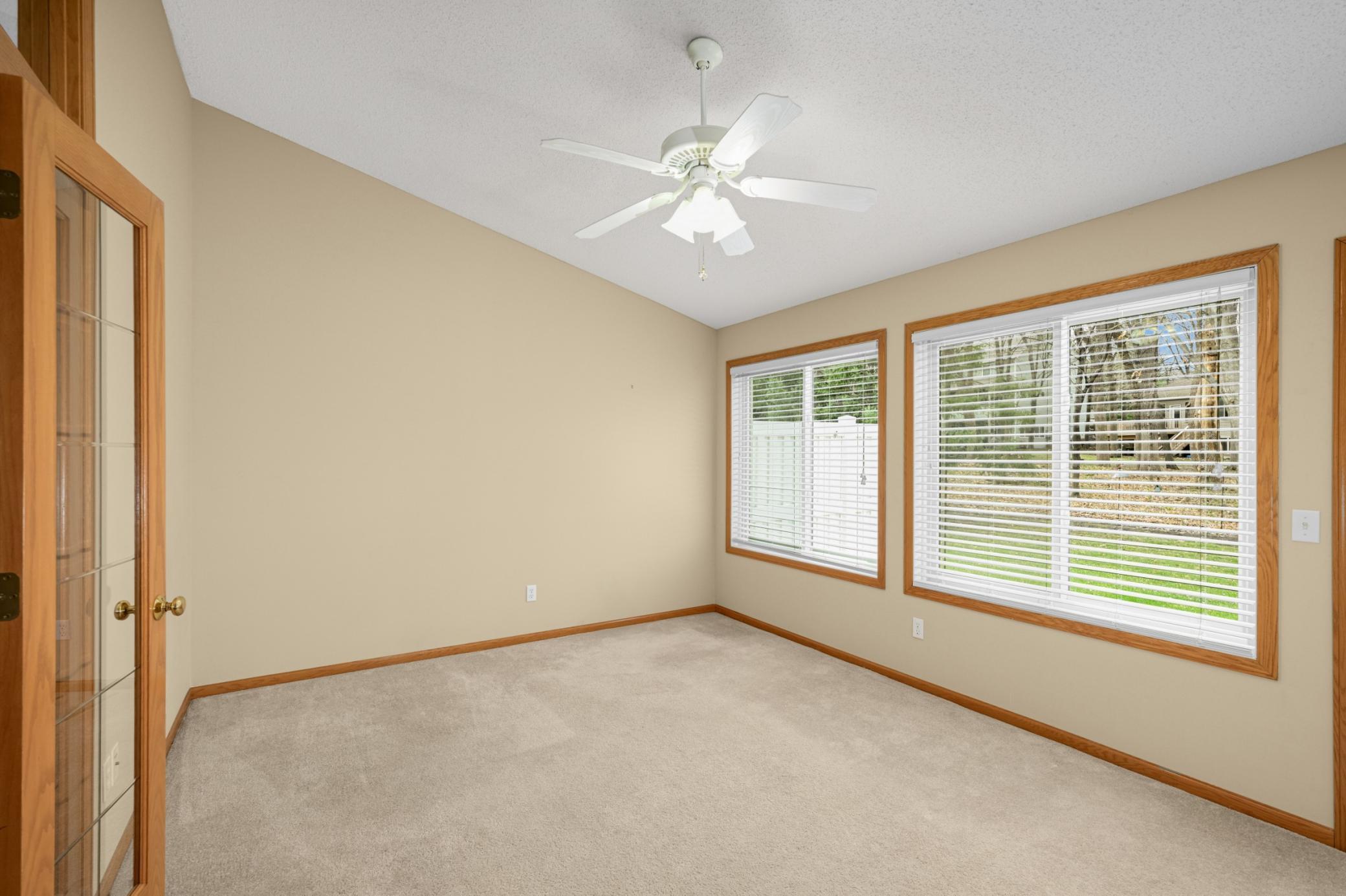 Sunroom with a full wall of windows and vaulted ceilings, offering bright, airy views year round