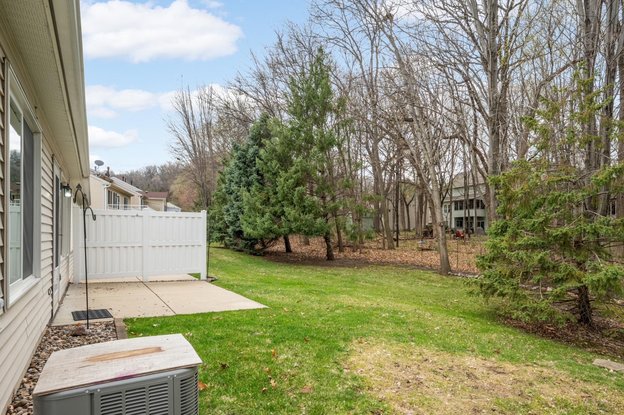 Wooded, serene back patio and green space offer a quiet outdoor escape