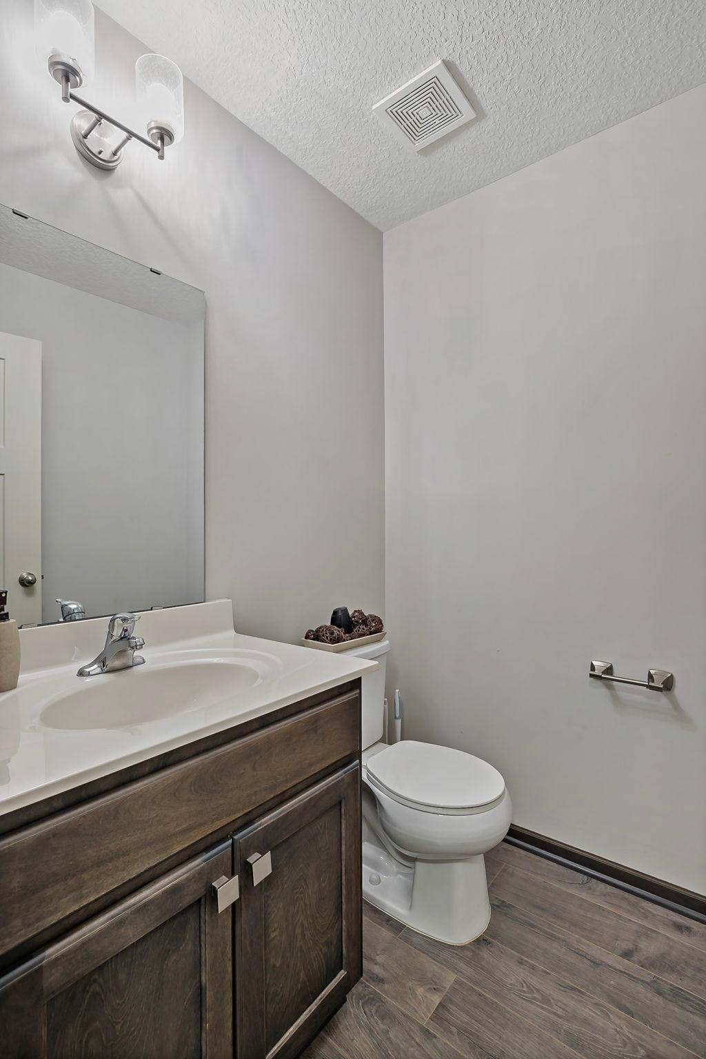 The main-level half bath offers convenient access for both residents and guests, providing a well-placed and functional space to meet everyday needs.