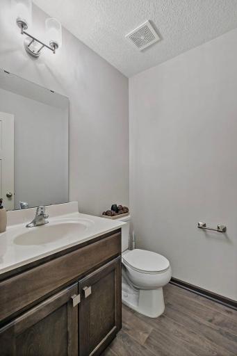 The main-level half bath offers convenient access for both residents and guests, providing a well-placed and functional space to meet everyday needs.