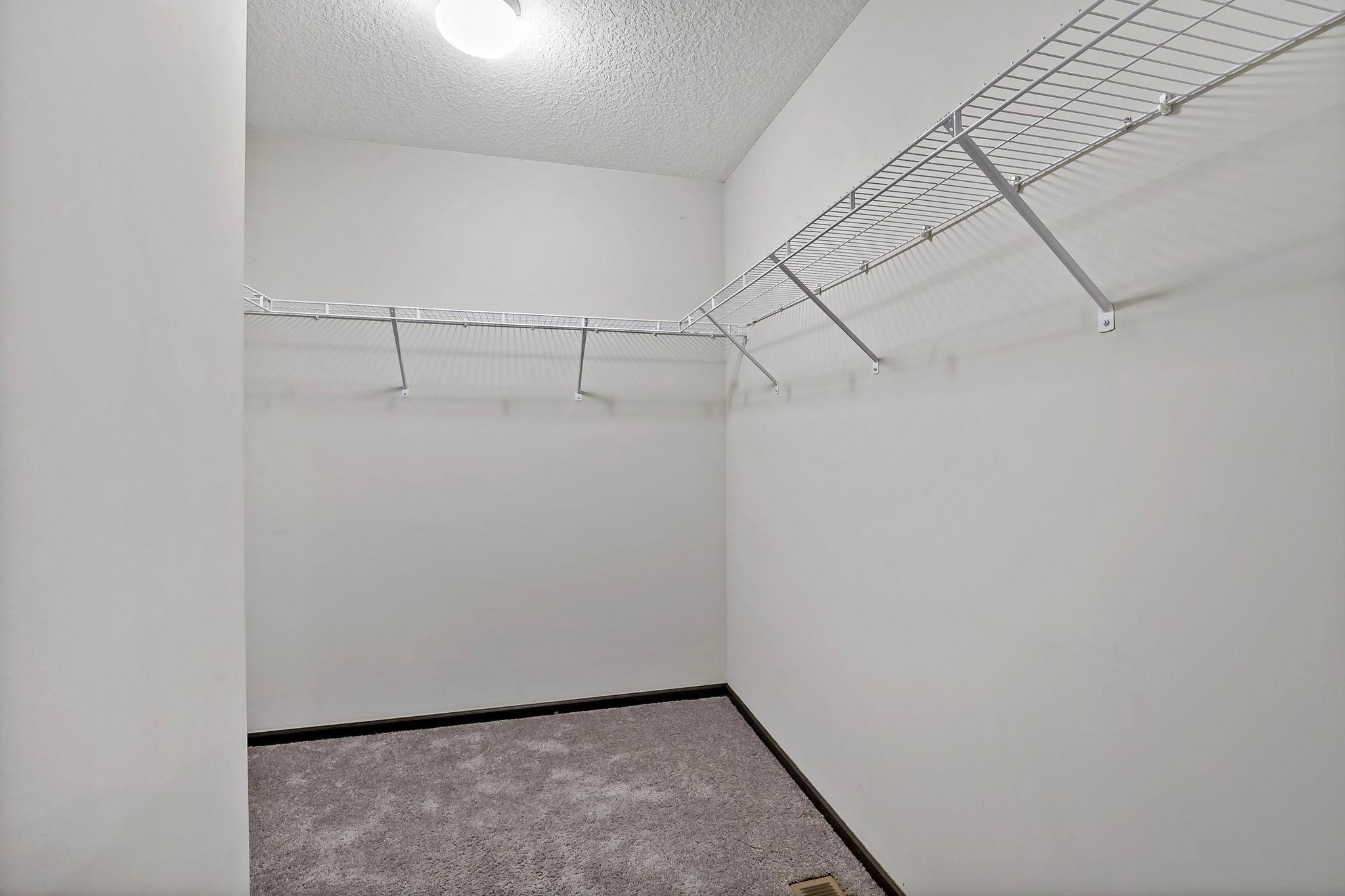 The primary walk-in closet offers ample space, providing excellent storage and an organized layout for clothing, shoes, and accessories.