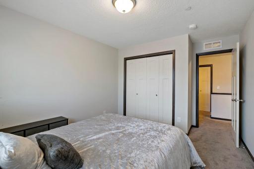 This upper-level bedroom offers a pleasant street view, providing a bright and inviting setting ideal for rest or work.