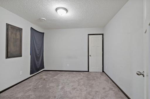 The lower-level bedroom includes an egress window for natural light and safety, along with a walk-in closet that provides excellent storage and functionality.
