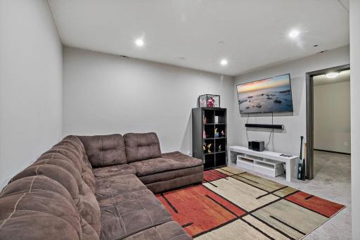 The lower-level family room features recessed lighting and a comfortable layout, creating a warm and inviting atmosphere.