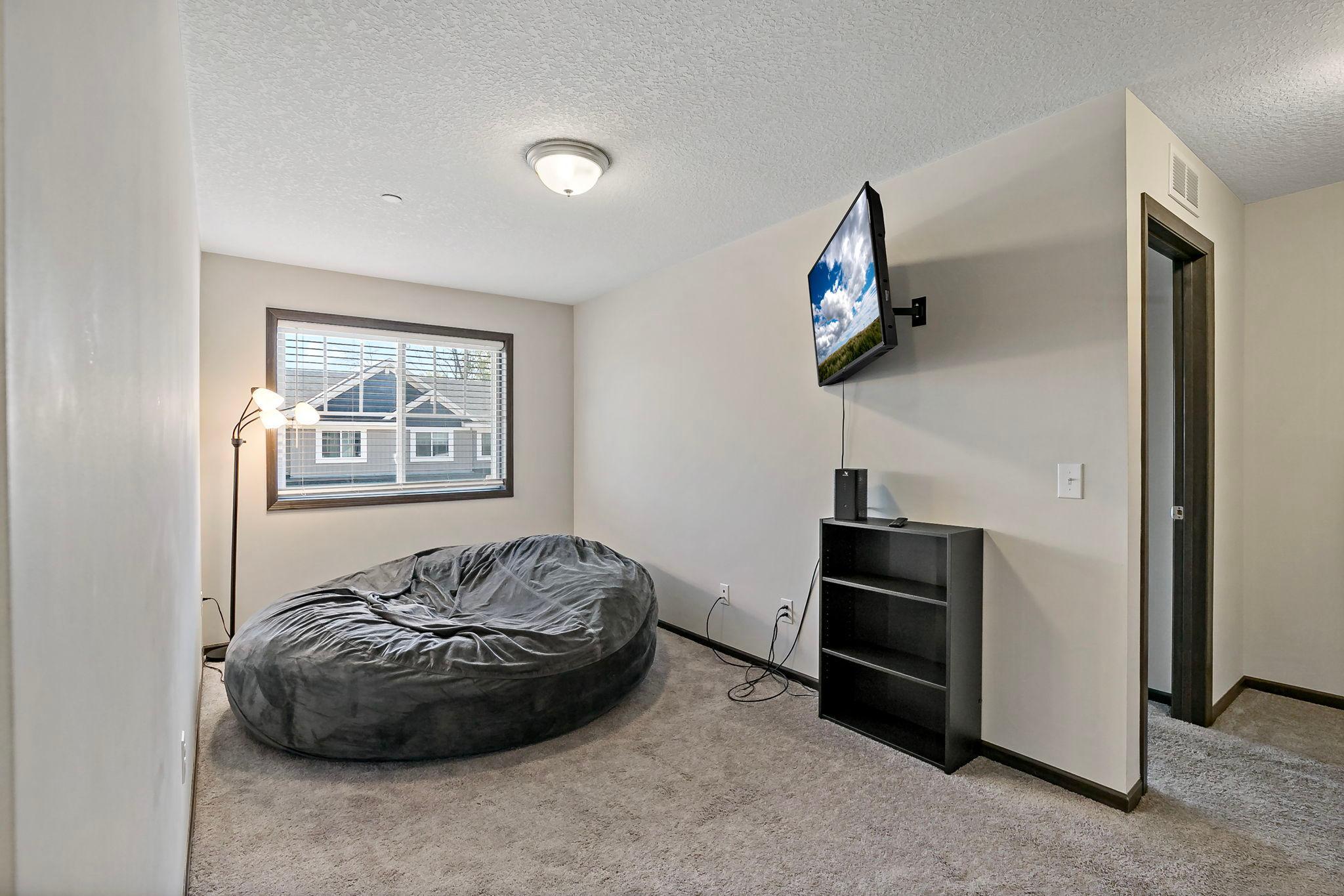 The upper-level loft provides a flexible space that can be customized to fit your lifestyle, whether used as a reading nook, home office, or additional lounge area.