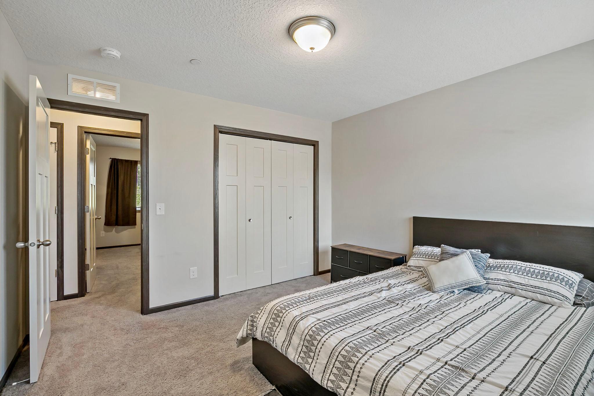 The third upper-level bedroom offers ample room size and is conveniently located across from the primary suite, providing a comfortable and versatile layout.