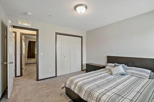 The third upper-level bedroom offers ample room size and is conveniently located across from the primary suite, providing a comfortable and versatile layout.