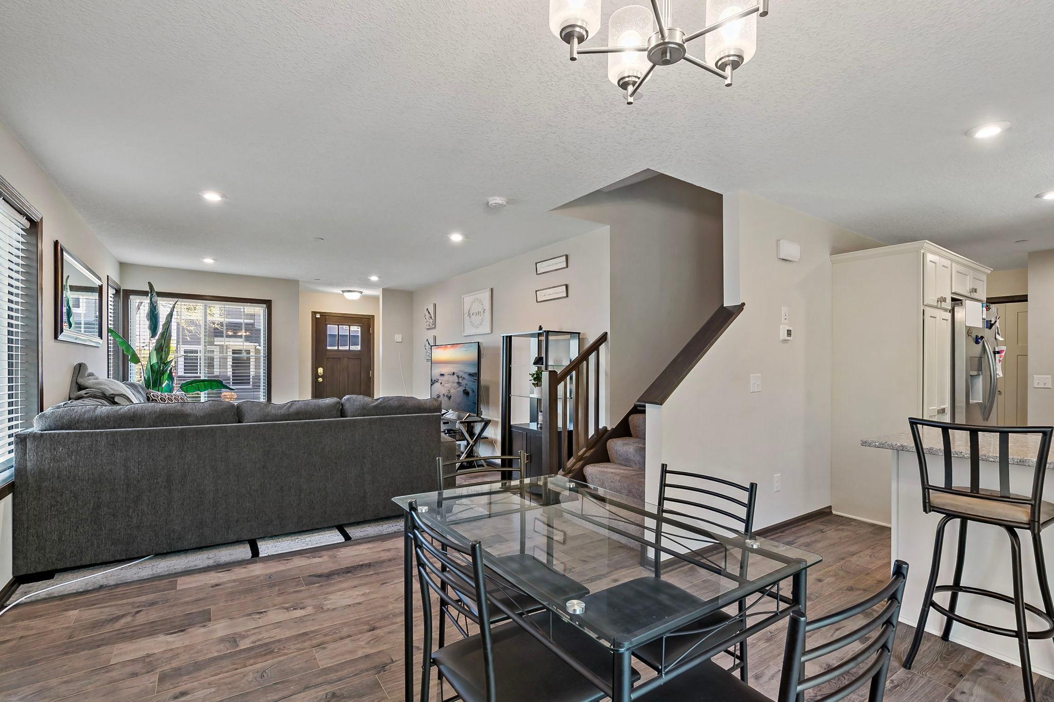 The dining area offers convenient access to the deck through a sliding glass door, making indoor and outdoor living effortless.