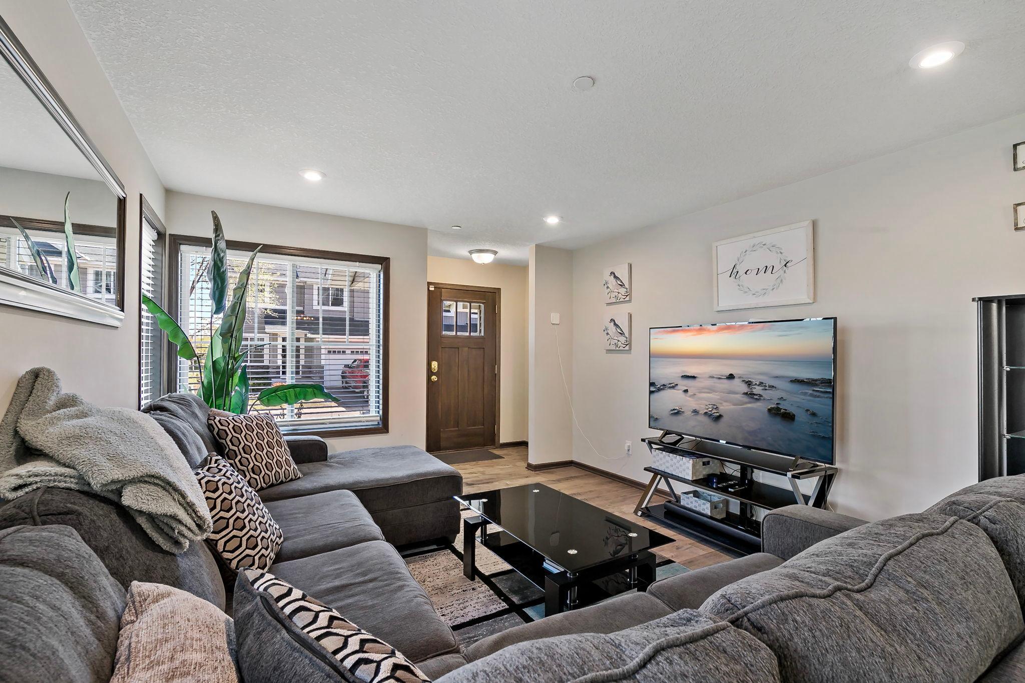 Upon entering the townhome, you’re welcomed by durable luxury vinyl plank flooring and a bright, inviting living space filled with natural light from large east- and south-facing windows.