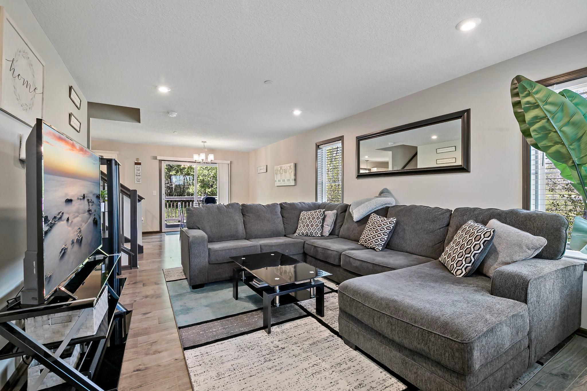 The main level flows seamlessly into the dining and kitchen area, creating an open and connected space ideal for both everyday living and entertaining.