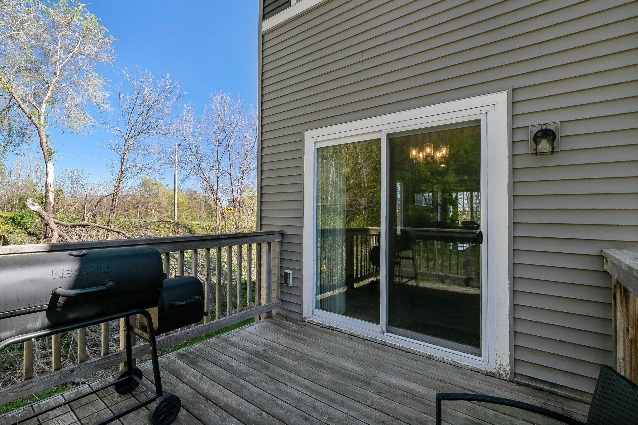The main-level deck, located just off the dining area, provides an ideal outdoor extension of the home with ample space for grilling and comfortable seating.