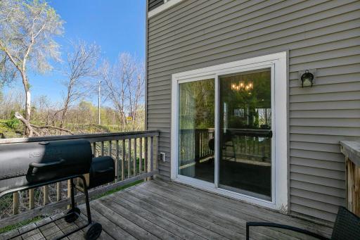 The main-level deck, located just off the dining area, provides an ideal outdoor extension of the home with ample space for grilling and comfortable seating.