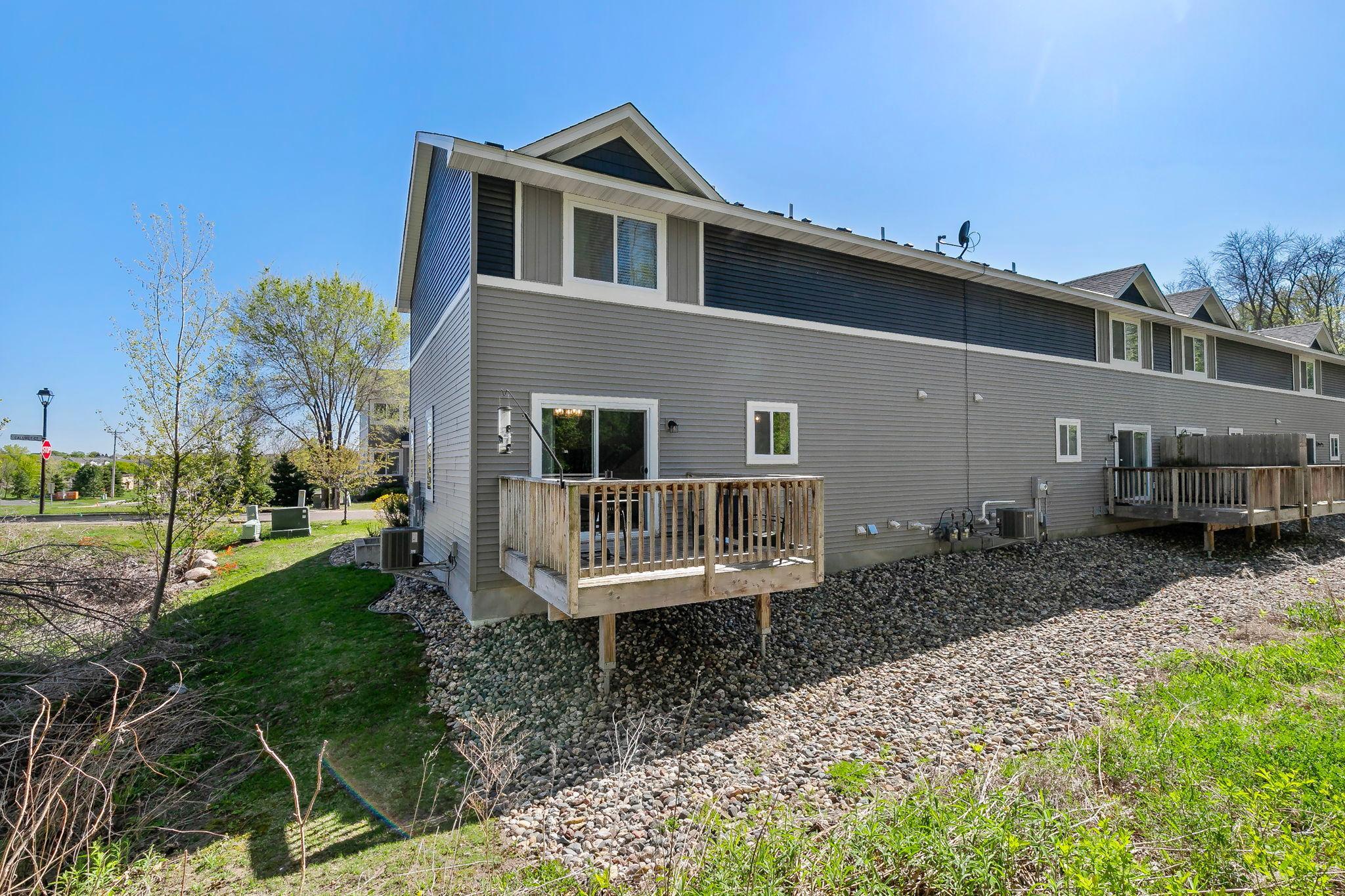 The backyard offers a low-maintenance outdoor setting with rock landscaping surrounding the perimeter for added curb appeal and functionality.