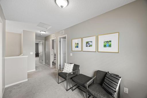 Highlighted by a versatile landing space that works well as a reading nook, office, or lounge.