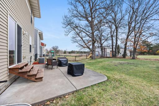 Private backyard patio framed by mature trees and open space! Perfect for quiet mornings or evening gatherings.
