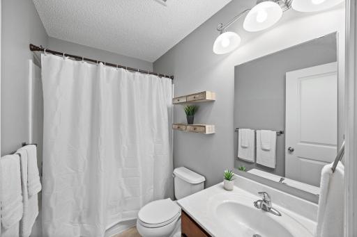 Adjacent shared full bathroom with vanity storage!
