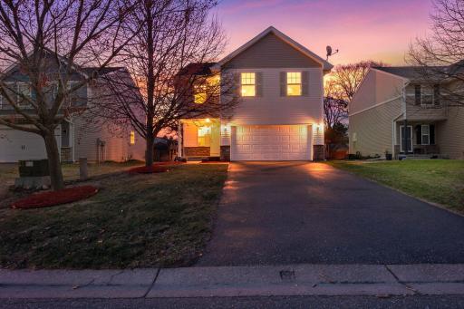 The landscaping adds to the home’s curb appeal, while the attached two-car garage offers reliable storage and vehicle protection year-round.