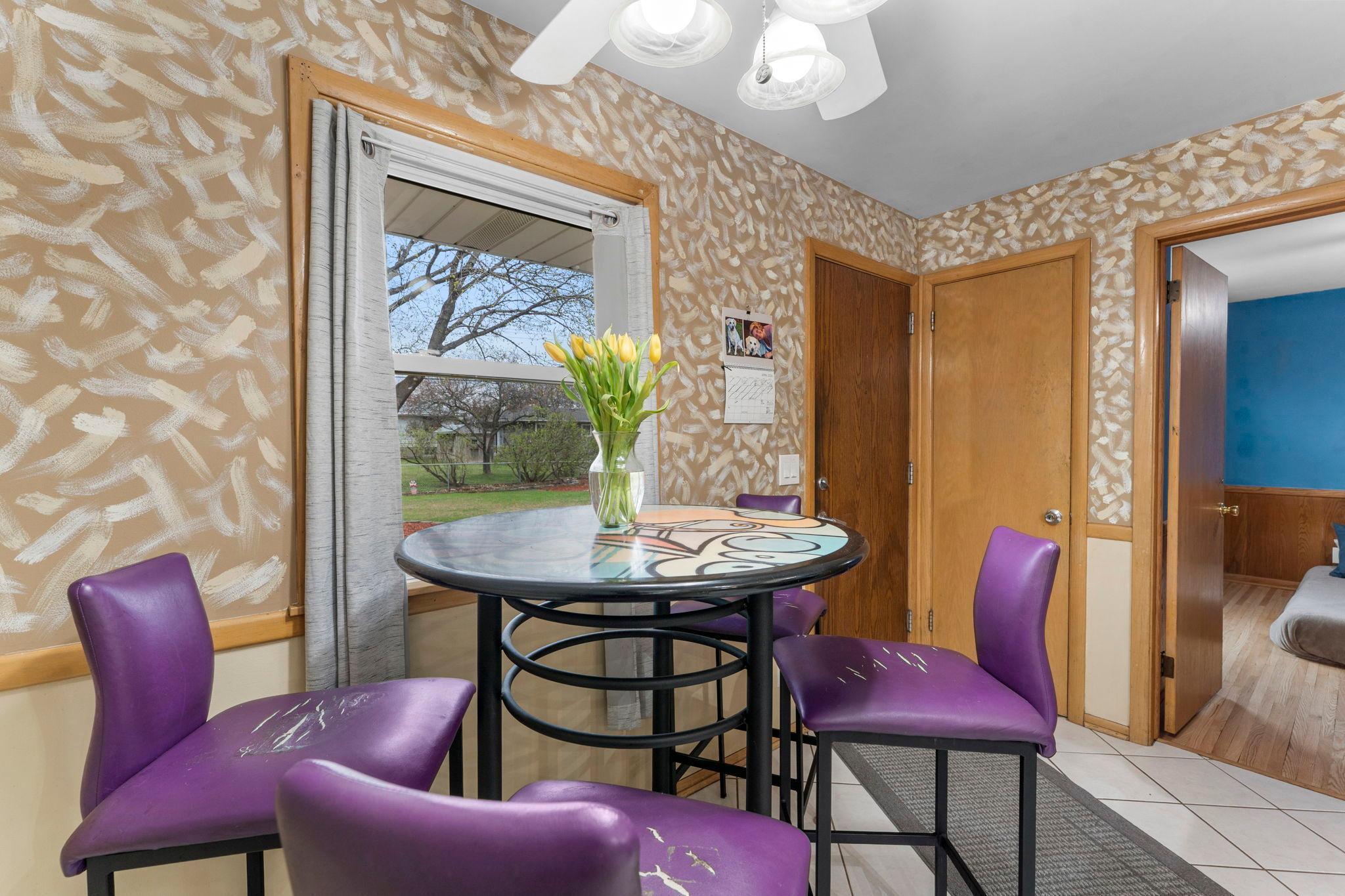 The informal dining area offers tile floors, a pantry closet, ceiling fan, and direct access to the patio and fully fenced backyard