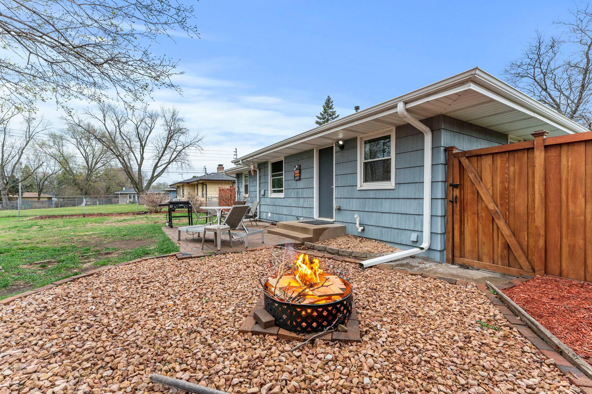 A look at the standout backyard patio and fully fenced yard, complete with updated landscaping and a dedicated fire pit area.