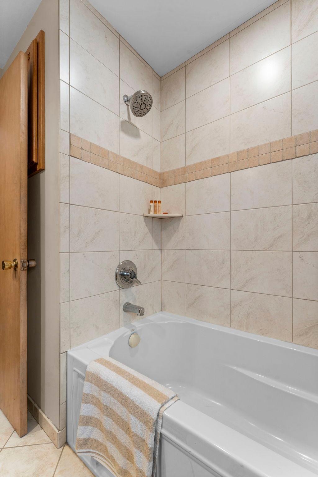 Updated soaking tub with tile surround.