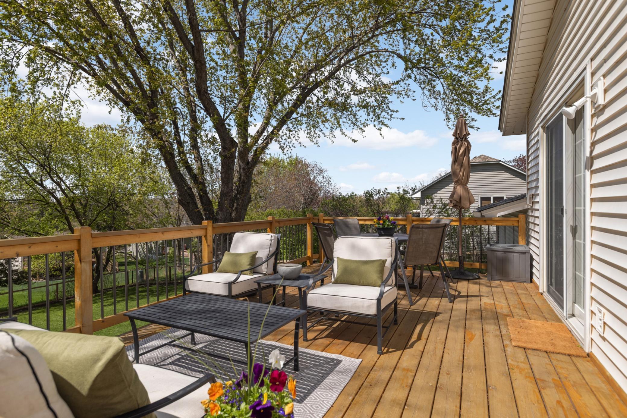 Picture enjoying an ice cold beverage on this beautiful deck with a park like backyard!