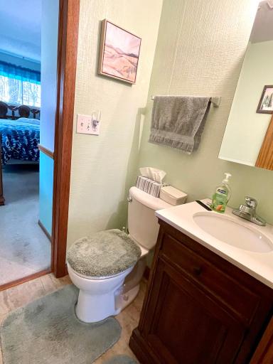 Half bath located in between the primary bedroom and kitchen