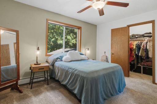 Primary bedroom with a walk-in closet and bathroom