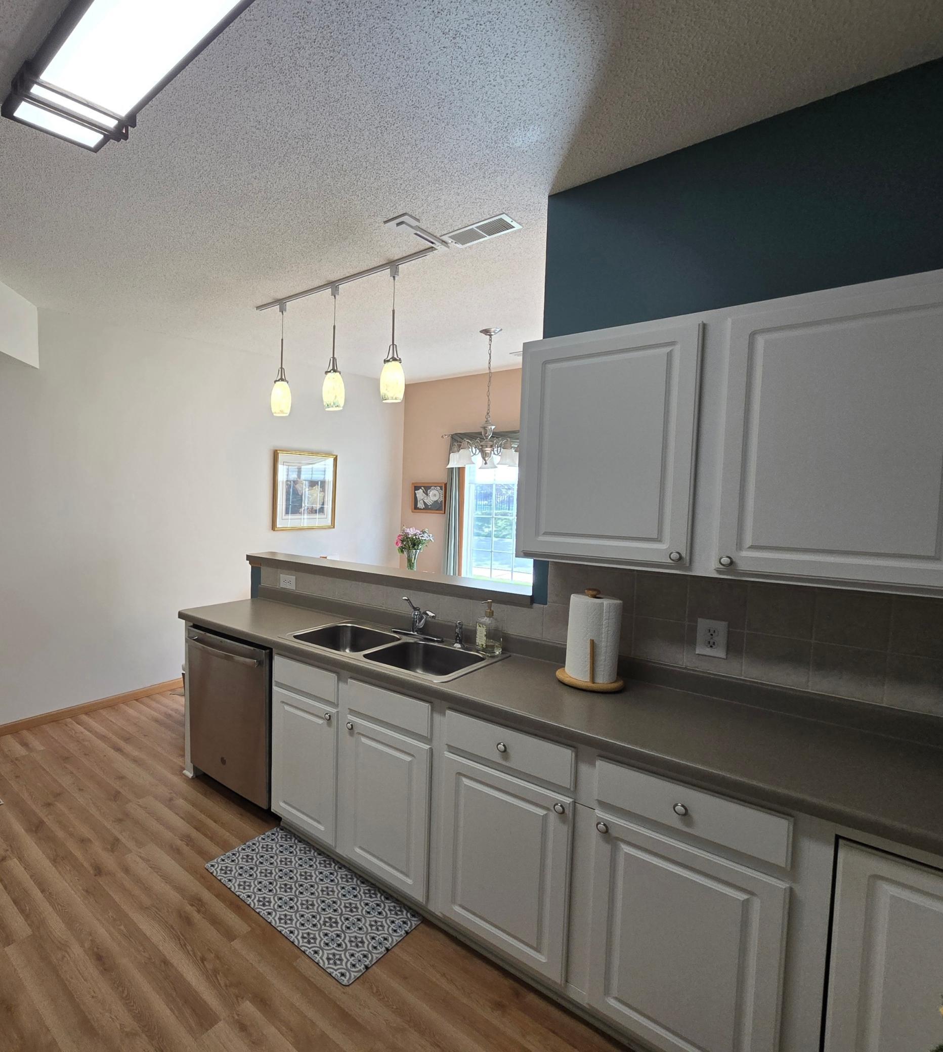 Kitchen overlooks sunny dining room