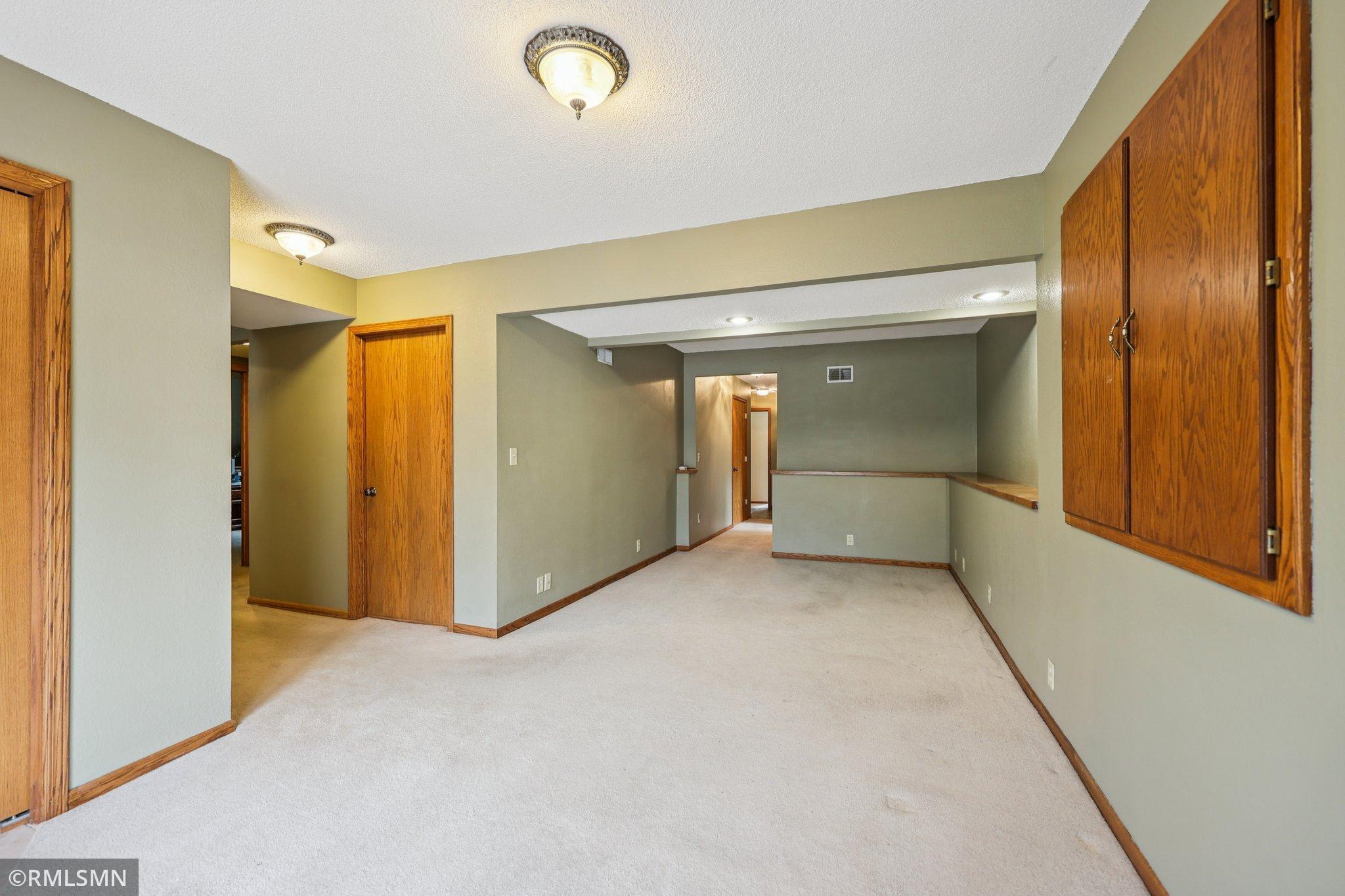 Family room view just inside the entry off the driveway. Entry is tiled with a coat closet