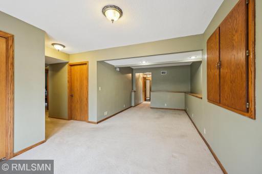 Family room view just inside the entry off the driveway. Entry is tiled with a coat closet