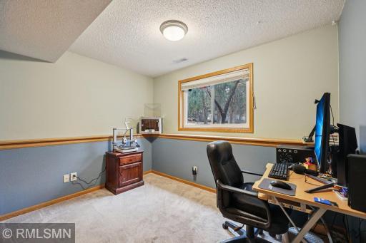 Bedroom 3 is currently used as an office, with views of the backyard