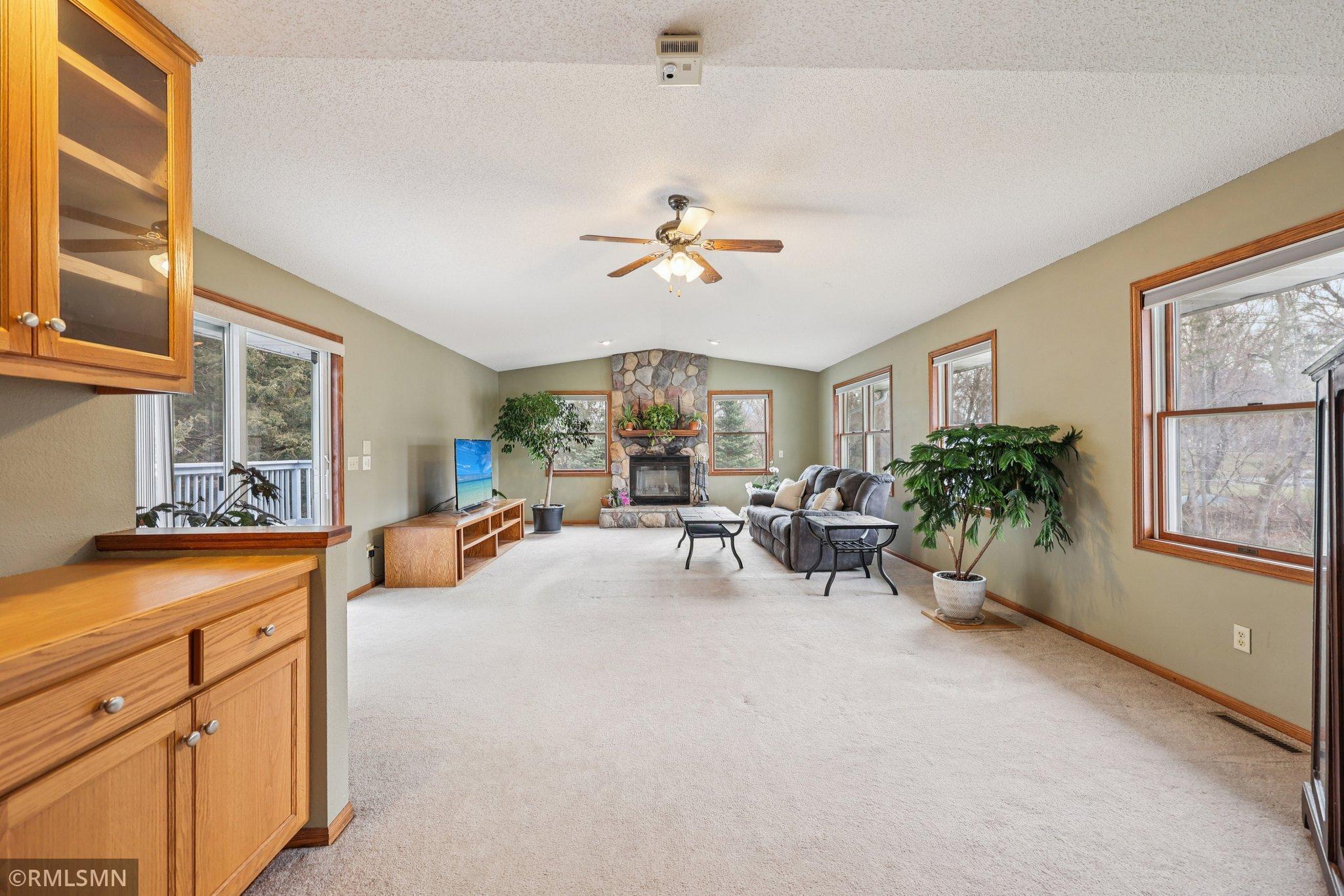 Giant great room with deck access and a wood-burning fireplace, just serviced and ready for use!