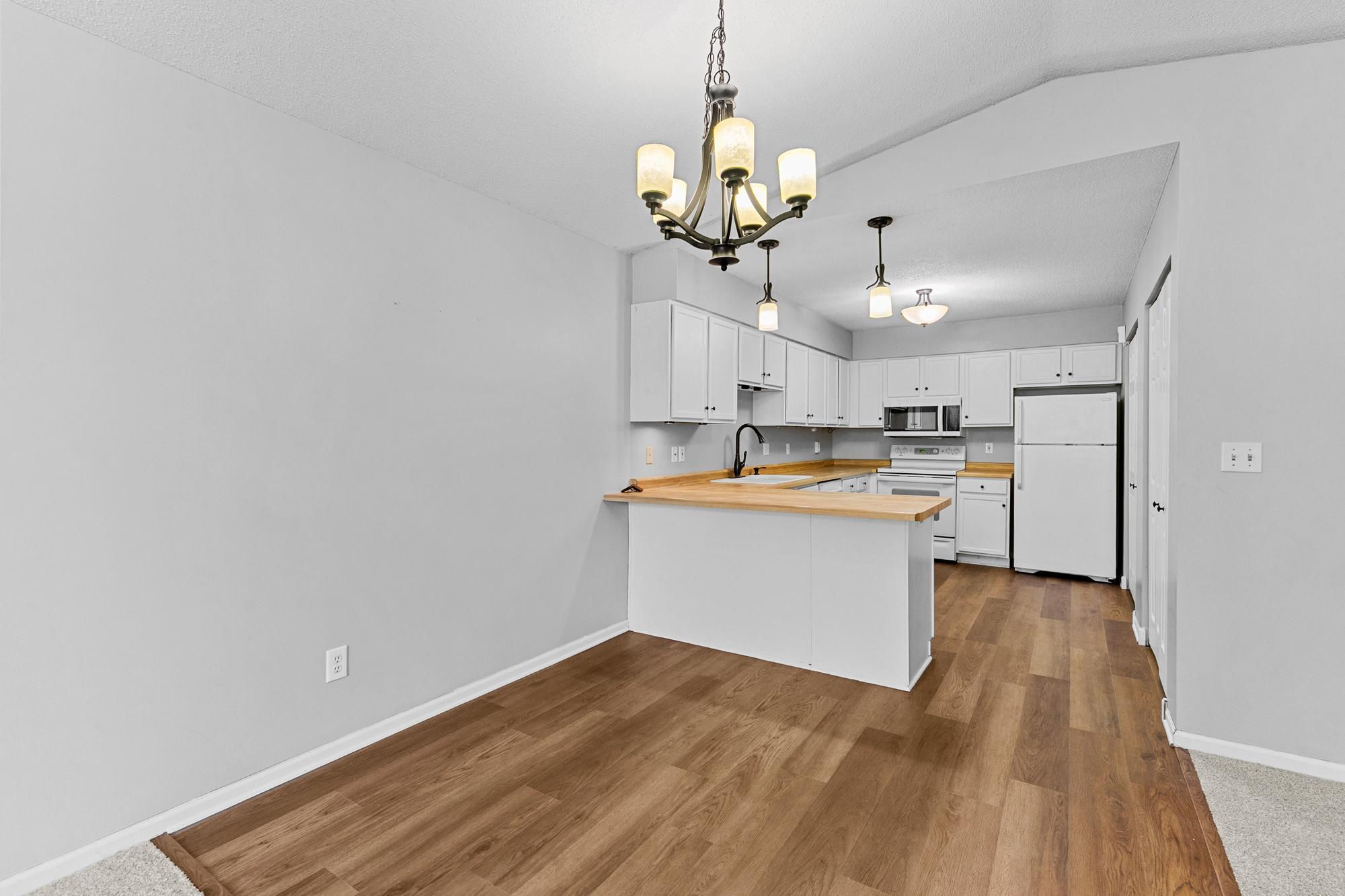 Kitchen with new flooring and a lot of storage. Updated lighting.
