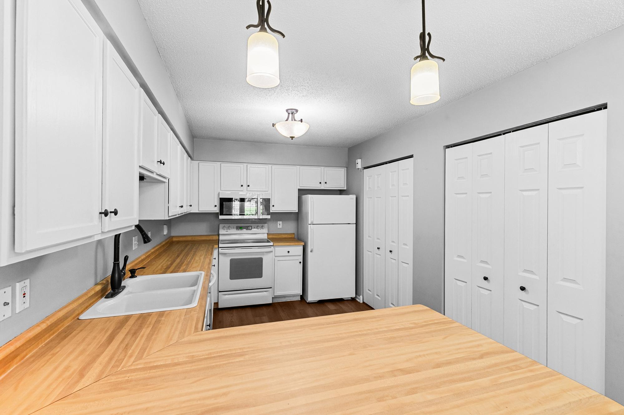 Kitchen with a large pantry and new microwave.