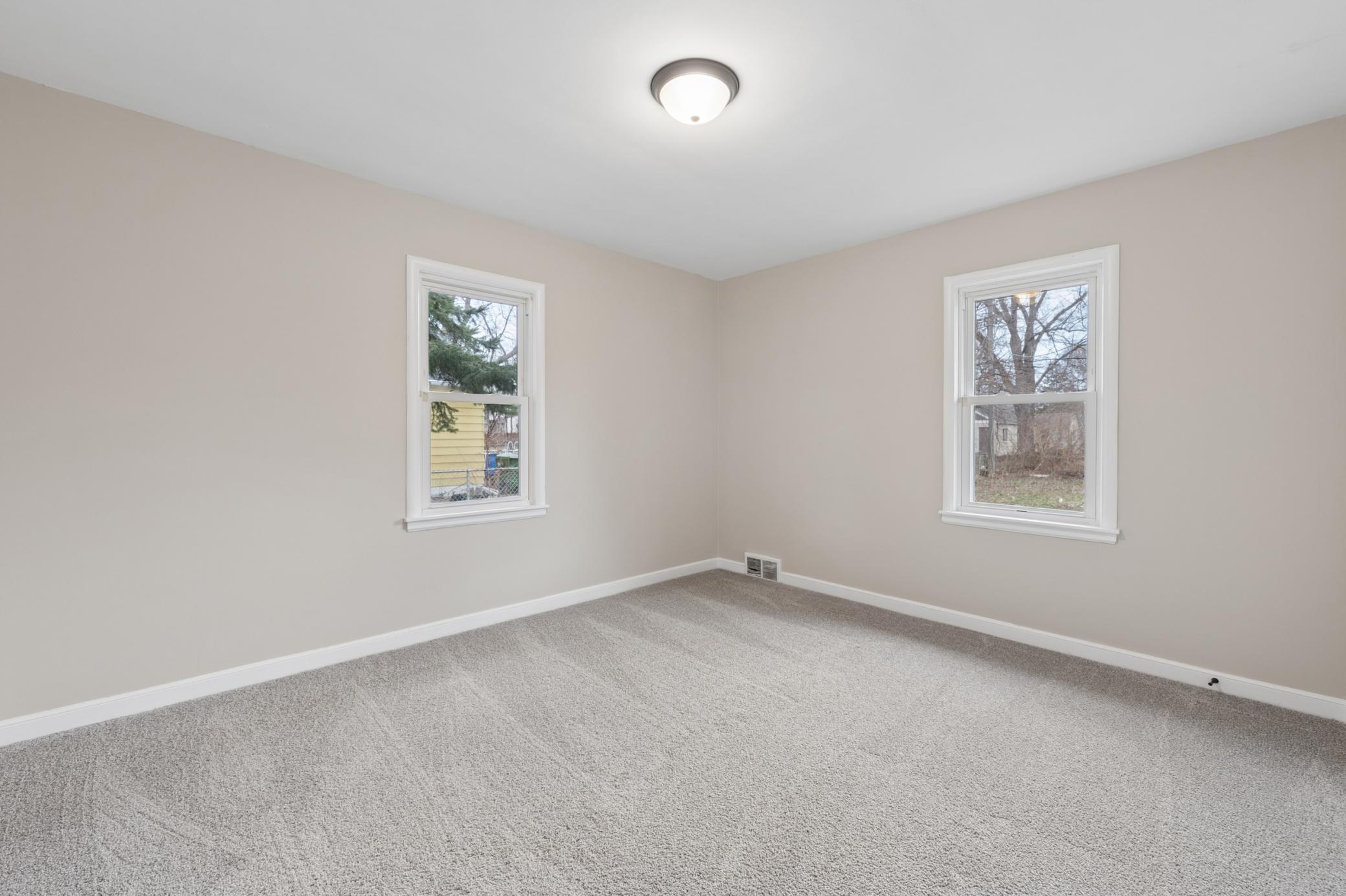 Generously sized bedroom with updated flooring, clean finishes, and ample space for furnishings.