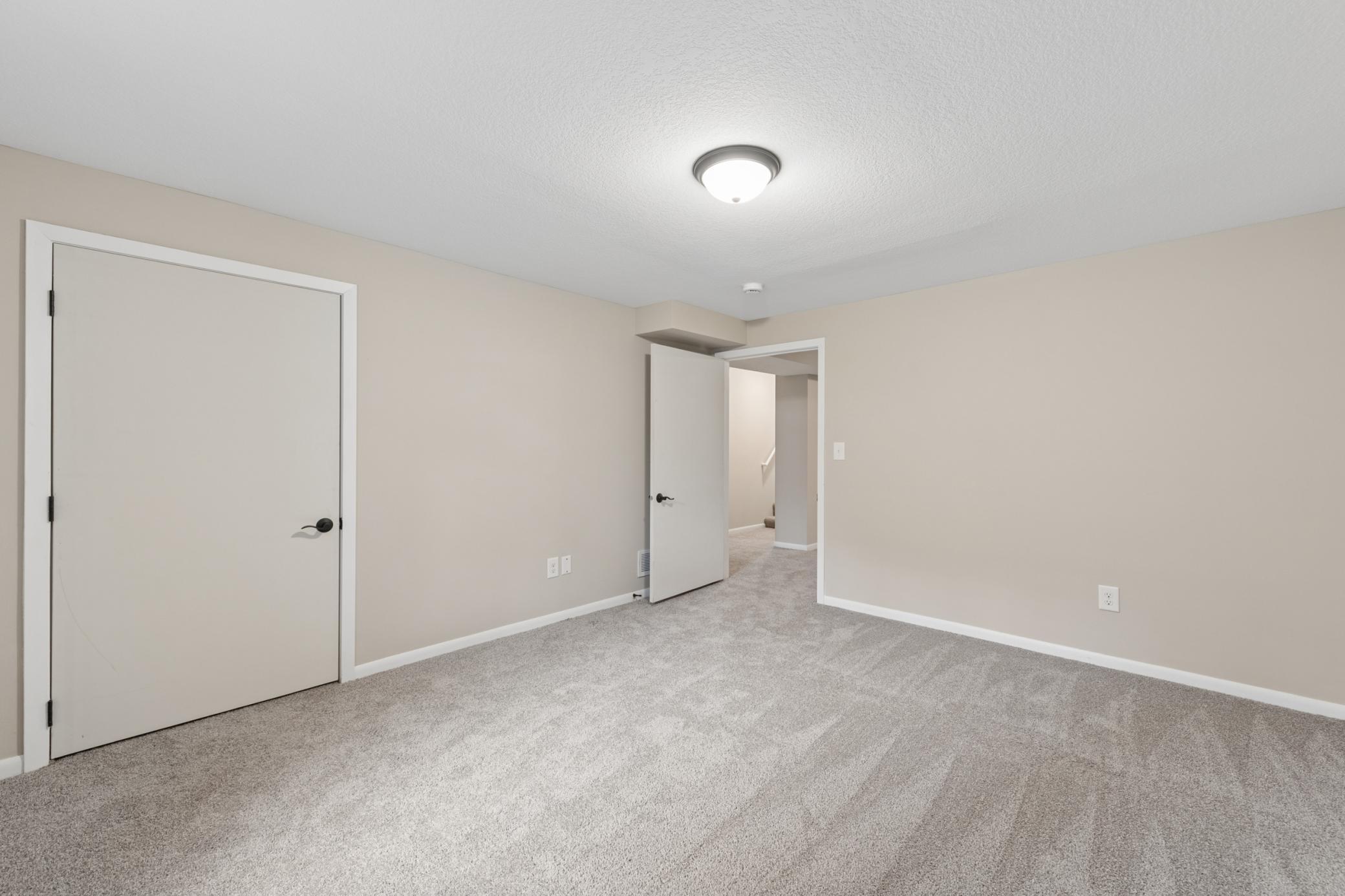 Additional lower-level space with natural light and versatile layout potential.