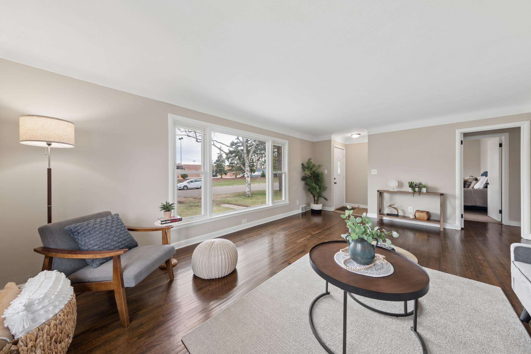 Inviting living area with oversized windows, cozy seating nook, and seamless flow throughout the main level.