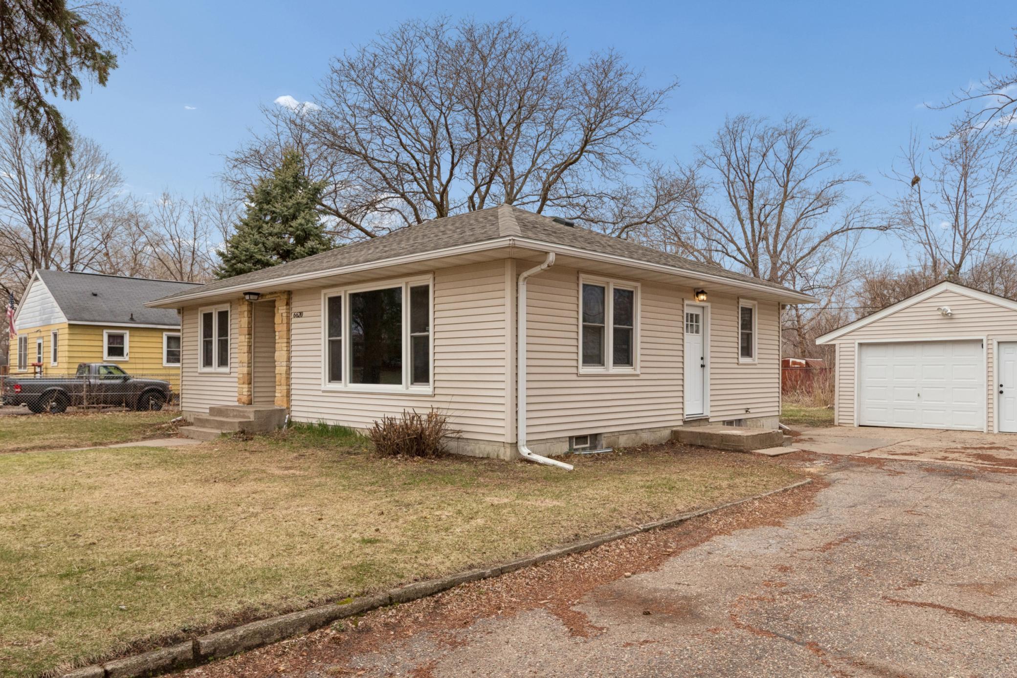 Charming front exterior with inviting entry, mature trees, and great curb appeal.