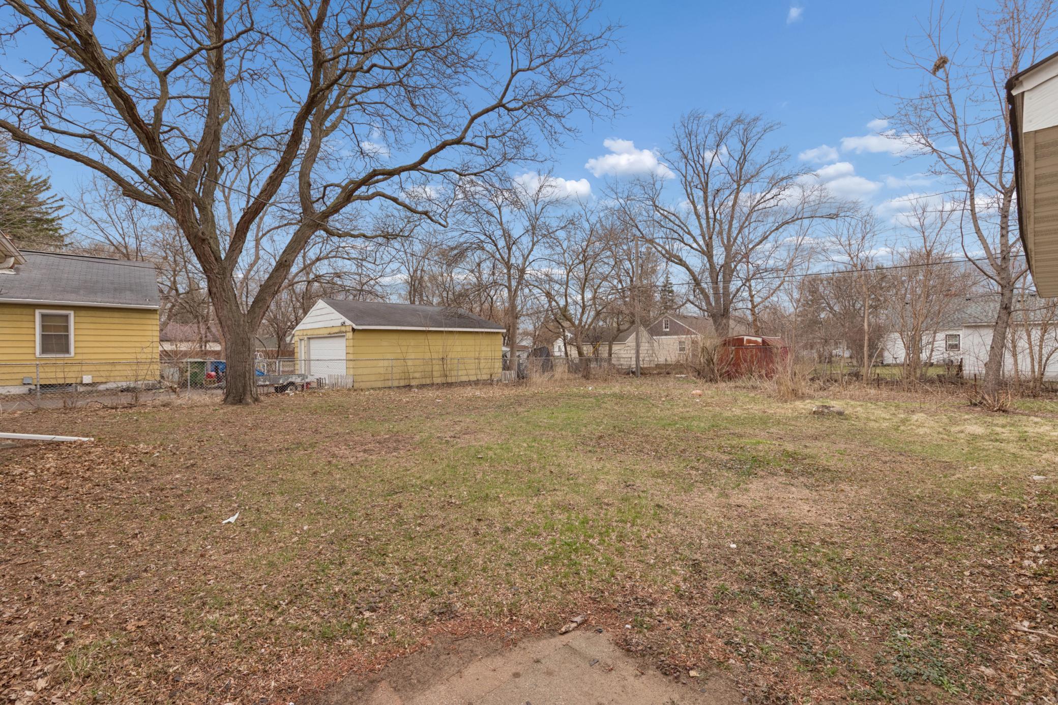 Generous backyard with mature trees and plenty of space for outdoor activities or future enhancements.