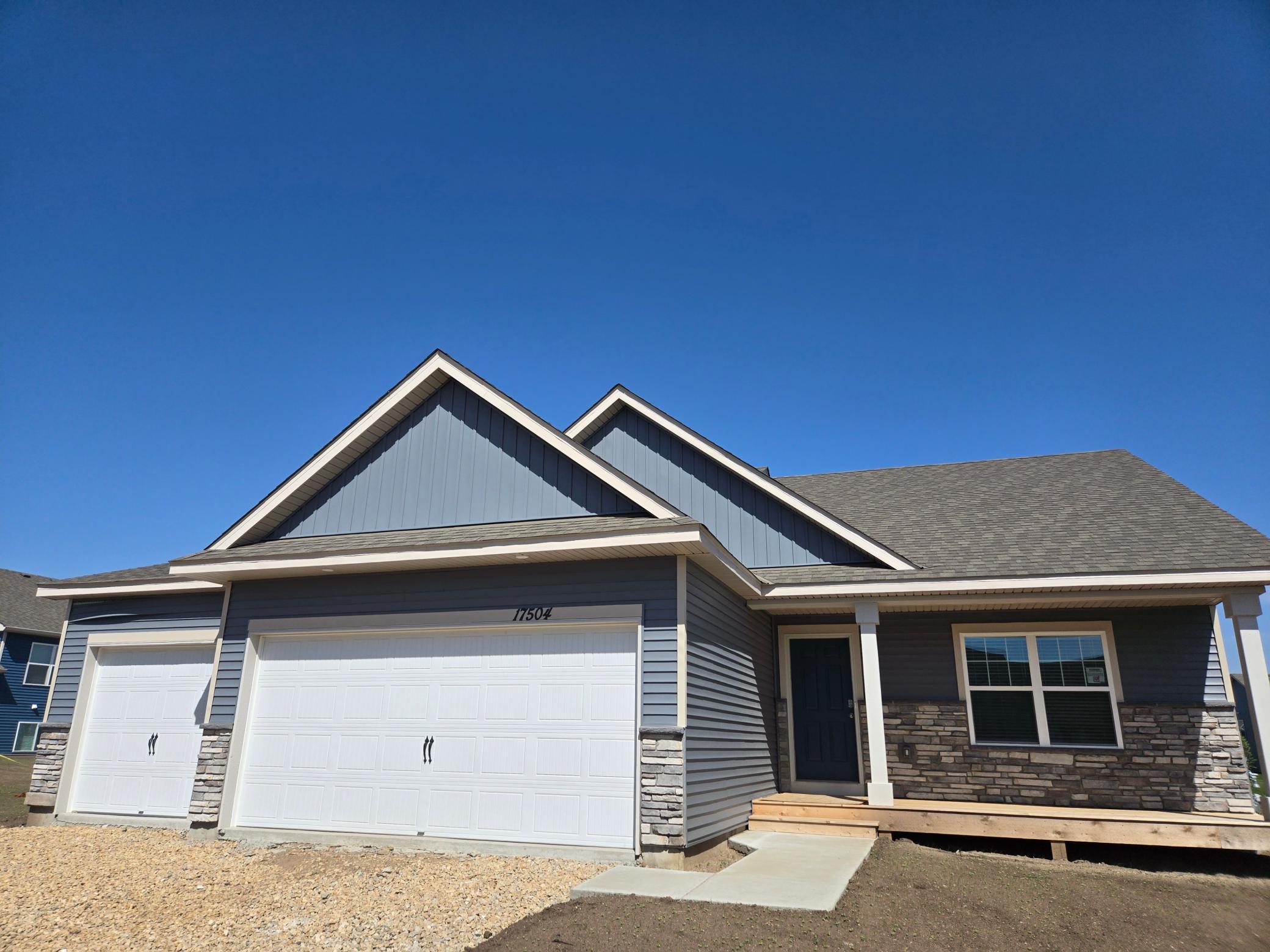 The Finnegan Heartland Cottage shown with optional stone at Highlands at Eagle View in Elko New Market. Photo is of a similar home. Options and colors may vary. Ask Sales Agent for details.
