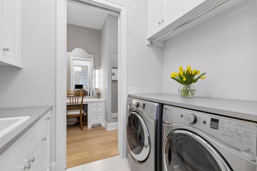 Main floor laundry space with a sink. Additional laundry room in the lower level