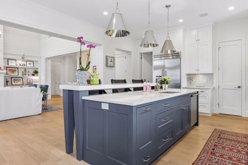 Bright and inviting kitchen with crisp finishes, designer backsplash, and spacious island seating.