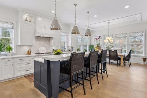 Stunning chef’s kitchen featuring a large center island, custom cabinetry, and elegant pendant lighting