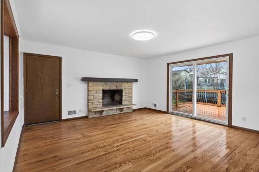 Dining room with wood fireplace and sliding door to Deck.