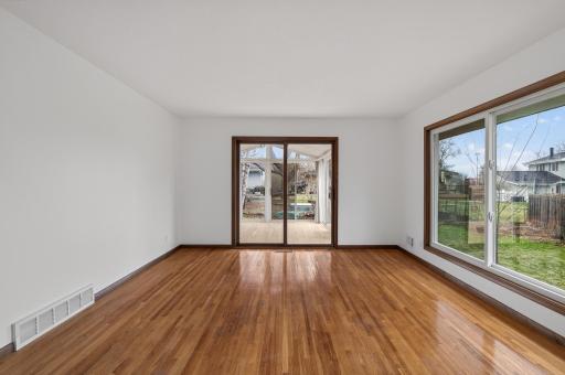 Refinished hardwood flooring and sliding door to the 3 season porch.