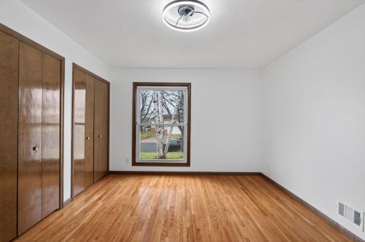 Primary bedroom with double closets, windows on two walls and 3/4 bath.