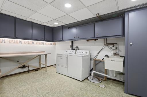 Large laundry room with plenty of cabinets and storage space along with the mechanicals.