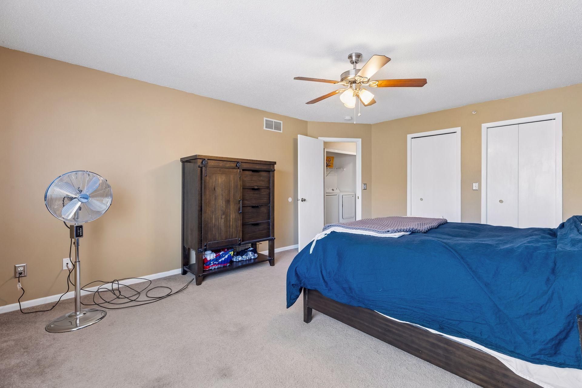 The primary bedroom is equipped with a ceiling fan for added comfort